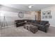 Bright living room with sectional sofa, accent chairs, and large clock at 22633 E Domingo Rd, Queen Creek, AZ 85142