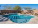 Inviting backyard pool with stone coping and desert landscaping at 22633 E Domingo Rd, Queen Creek, AZ 85142