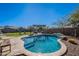 Inviting kidney-shaped pool with stone coping at 22633 E Domingo Rd, Queen Creek, AZ 85142
