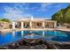 Expansive backyard with a large pool, spa, and a beautiful water feature at 23204 N Paseo Laredo Ln, Peoria, AZ 85383
