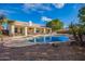 Spacious backyard oasis featuring a large pool, spa, and covered patio at 23204 N Paseo Laredo Ln, Peoria, AZ 85383