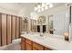 Bathroom with vanity, bathtub, and striped shower curtain at 23204 N Paseo Laredo Ln, Peoria, AZ 85383