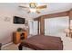 Bedroom with double bed, ceiling fan, and double doors at 23204 N Paseo Laredo Ln, Peoria, AZ 85383