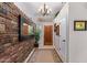 Stone accent wall and wood flooring in entryway at 23204 N Paseo Laredo Ln, Peoria, AZ 85383