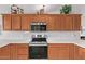 Modern kitchen with stainless steel appliances and wood cabinets at 23204 N Paseo Laredo Ln, Peoria, AZ 85383