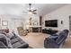 Spacious living room with fireplace and large TV at 23204 N Paseo Laredo Ln, Peoria, AZ 85383