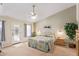 Main bedroom with a king-size bed, ceiling fan, and access to a patio at 23204 N Paseo Laredo Ln, Peoria, AZ 85383