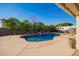 Inviting kidney-shaped pool with a spa and spacious patio area at 23204 N Paseo Laredo Ln, Peoria, AZ 85383