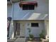 Well-maintained townhouse with attractive landscaping and a red awning at 2545 W Rose Ln # A-2, Phoenix, AZ 85017