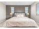 Main bedroom with dark brown dresser and large bed, offering natural light at 26049 S 230Th St, Queen Creek, AZ 85142