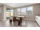Bright dining area with wooden table and chairs, offering access to backyard at 26049 S 230Th St, Queen Creek, AZ 85142