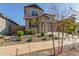 Two-story house with tan exterior, two-car garage, and landscaping at 26049 S 230Th St, Queen Creek, AZ 85142