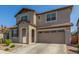 Two-story house with tan exterior, two-car garage, and landscaping at 26049 S 230Th St, Queen Creek, AZ 85142