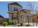 Two-story house with tan exterior, two-car garage, and landscaping at 26049 S 230Th St, Queen Creek, AZ 85142