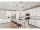 Modern kitchen featuring white cabinets, quartz countertops, and a large island at 26049 S 230Th St, Queen Creek, AZ 85142