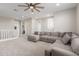 Open living area with sectional sofa and ceiling fan at 26049 S 230Th St, Queen Creek, AZ 85142