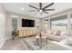Spacious living room with neutral color palette, large TV, and cozy seating at 26049 S 230Th St, Queen Creek, AZ 85142