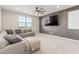 Spacious living room with sectional sofa and large TV at 26049 S 230Th St, Queen Creek, AZ 85142