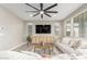 Spacious living room with neutral color palette, large TV, and cozy seating at 26049 S 230Th St, Queen Creek, AZ 85142