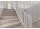 Carpeted staircase with white railing and access to upper floor at 26049 S 230Th St, Queen Creek, AZ 85142