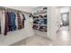 Large walk-in closet with shelving and hanging rods at 26049 S 230Th St, Queen Creek, AZ 85142