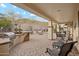 Landscaped backyard with a covered patio and built-in grill at 31538 N Larkspur Dr, San Tan Valley, AZ 85143