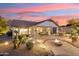 Backyard patio with fire pit and seating area at sunset at 31538 N Larkspur Dr, San Tan Valley, AZ 85143