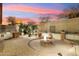 Landscaped backyard with fire pit and built-in grill at 31538 N Larkspur Dr, San Tan Valley, AZ 85143