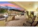 Relaxing backyard patio featuring a fire pit and outdoor kitchen at 31538 N Larkspur Dr, San Tan Valley, AZ 85143