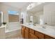 Bathroom with double vanity, soaking tub, and shower at 31538 N Larkspur Dr, San Tan Valley, AZ 85143