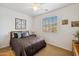 Guest bedroom with a queen bed and decorative wall art at 31538 N Larkspur Dr, San Tan Valley, AZ 85143