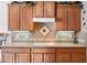 Kitchen features cooktop and beautiful tile backsplash at 31538 N Larkspur Dr, San Tan Valley, AZ 85143