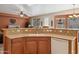 Kitchen island with sink, dishwasher, and breakfast bar at 31538 N Larkspur Dr, San Tan Valley, AZ 85143