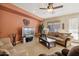 Spacious living room with neutral colored furniture and a large TV at 31538 N Larkspur Dr, San Tan Valley, AZ 85143