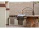 Built-in outdoor kitchen with grill and bar area at 31538 N Larkspur Dr, San Tan Valley, AZ 85143
