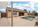 Inviting backyard with refreshing pool, patio, and shade structure at 3376 S 256Th Dr, Buckeye, AZ 85326
