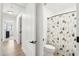 Clean bathroom with patterned shower curtain at 3376 S 256Th Dr, Buckeye, AZ 85326