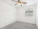 Small bedroom with ceiling fan and neutral decor at 3376 S 256Th Dr, Buckeye, AZ 85326