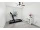 Bedroom with treadmill, desk and large window at 3376 S 256Th Dr, Buckeye, AZ 85326