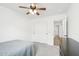 Bright bedroom with double door closet and ceiling fan at 3376 S 256Th Dr, Buckeye, AZ 85326