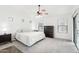 Bright bedroom with a king-size bed, ceiling fan, and ample natural light at 3376 S 256Th Dr, Buckeye, AZ 85326