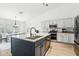 Modern kitchen with large island, stainless steel appliances, and white cabinets at 3376 S 256Th Dr, Buckeye, AZ 85326