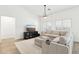 Open living area with L-shaped sofa, TV, and hardwood floors at 3376 S 256Th Dr, Buckeye, AZ 85326