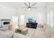 Living room with L-shaped sofa, fireplace, and hardwood floors at 3376 S 256Th Dr, Buckeye, AZ 85326