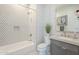 Modern bathroom features a bathtub with stylish tile surround and a gray vanity with a white countertop at 35065 N 83Rd Pl # 4, Scottsdale, AZ 85266