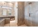 Updated bathroom featuring tile shower, vanity with undermount sink, and chevron tile accent wall at 35065 N 83Rd Pl # 4, Scottsdale, AZ 85266