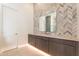 Modern bathroom with chevron tile accent wall, undermount sink and under cabinet lighting at 35065 N 83Rd Pl # 4, Scottsdale, AZ 85266