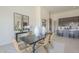 Elegant dining room with modern table, wicker chairs, stylish mirrors, and seamless access to the kitchen at 35065 N 83Rd Pl # 4, Scottsdale, AZ 85266