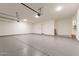 Spacious garage with sealed concrete flooring, ample lighting, and storage racks at 35065 N 83Rd Pl # 4, Scottsdale, AZ 85266