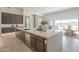 Open kitchen design with large island, sleek cabinetry, modern appliances, and seamless flow into the living space at 35065 N 83Rd Pl # 4, Scottsdale, AZ 85266
